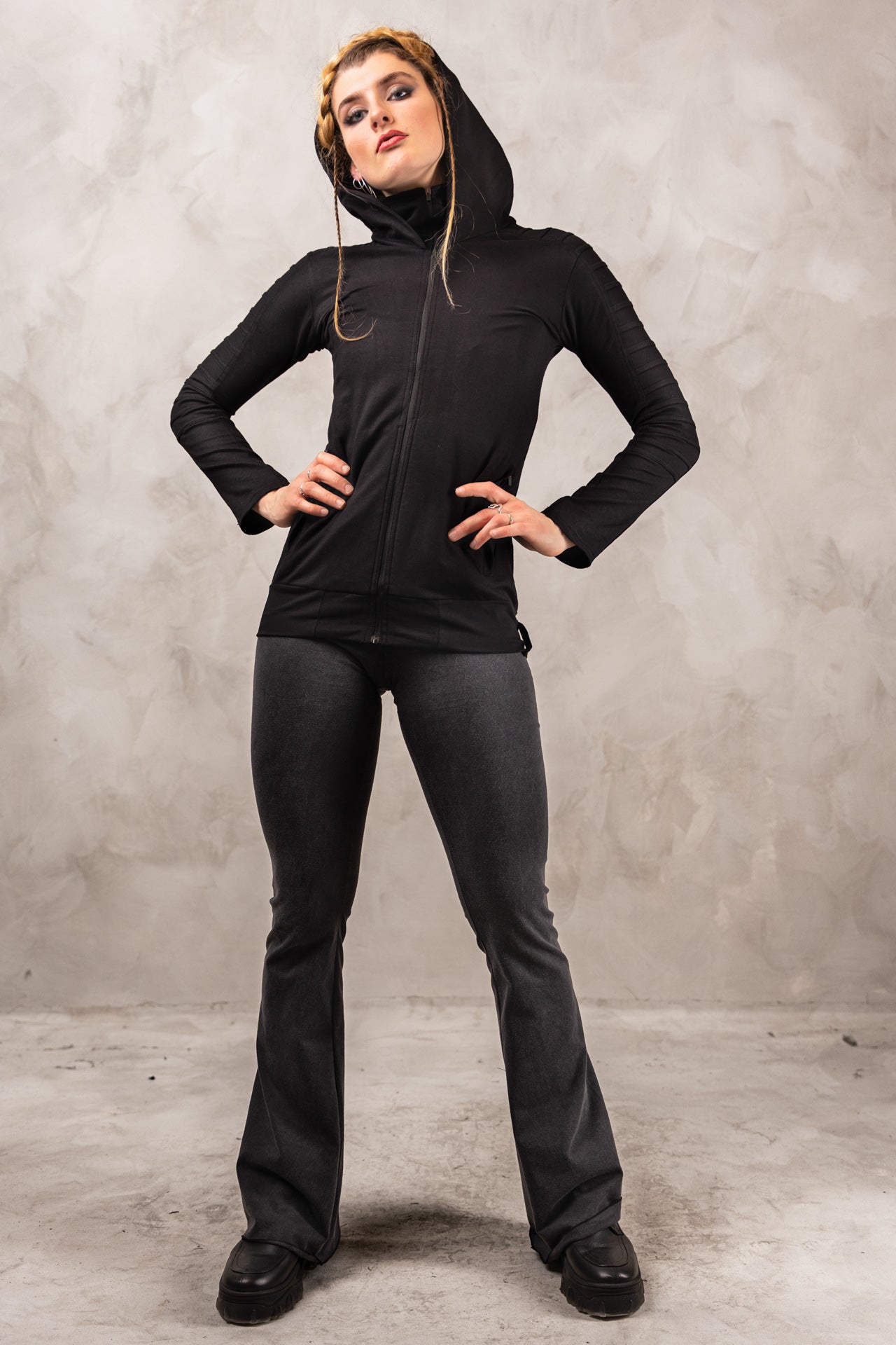 a woman in a black hoodie posing for a picture