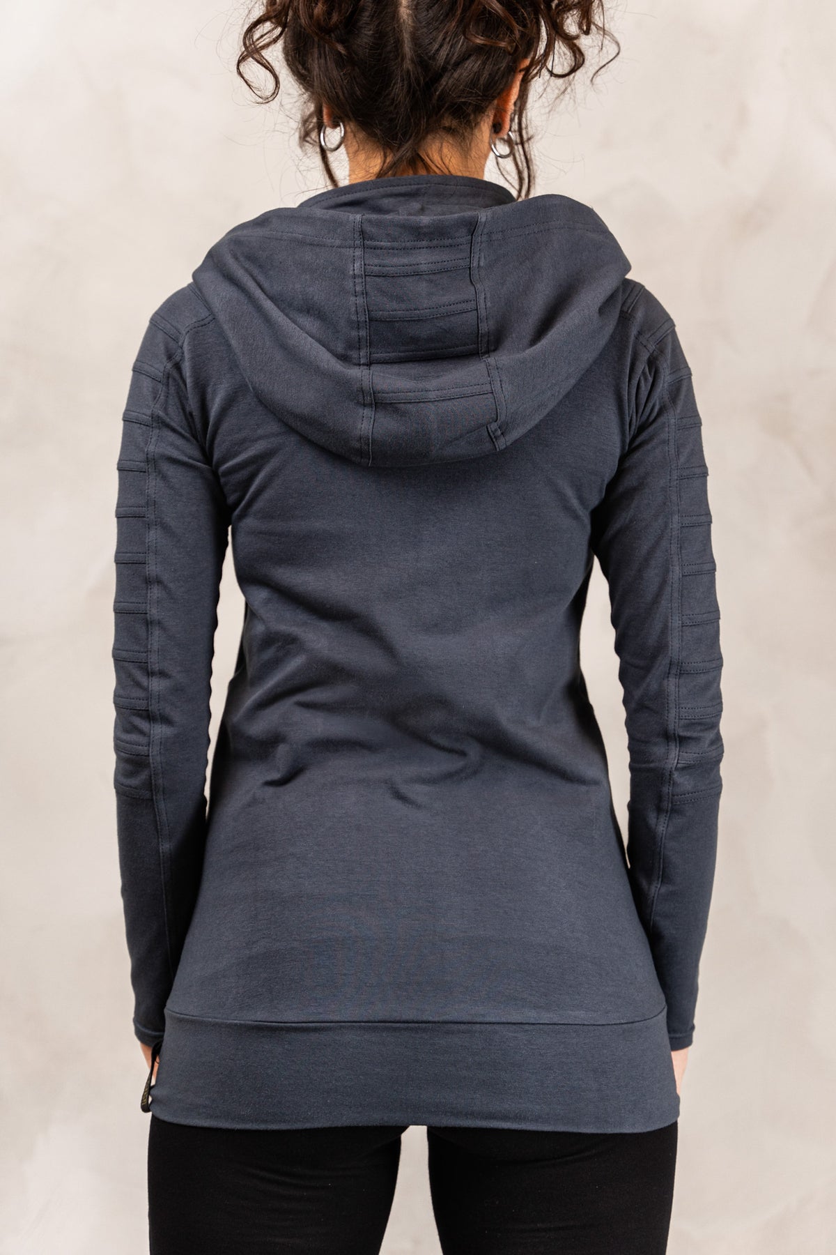 the back of a woman wearing a black hoodie